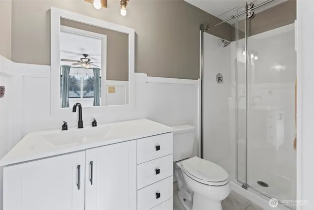 a bathroom with a sink toilet and shower