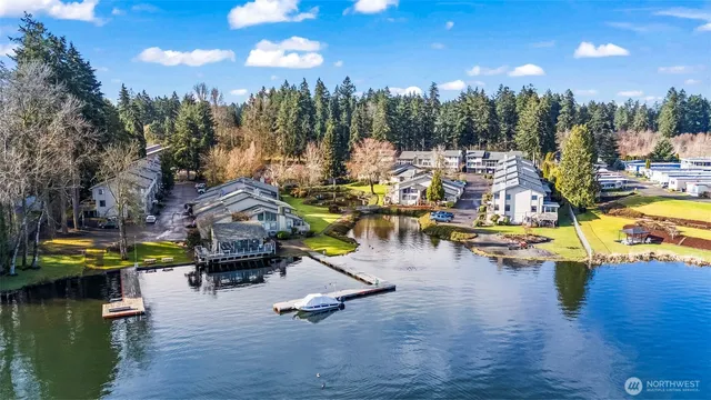 a view of a lake with boats and trees in the background