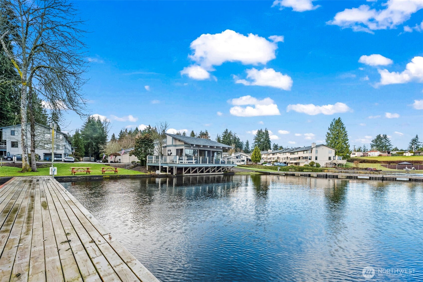 17303 Spanaway Loop Road South, Unit 18 Spanaway, WA 98387 - Photo 29 of 33 a view of a lake with boats and trees in the background