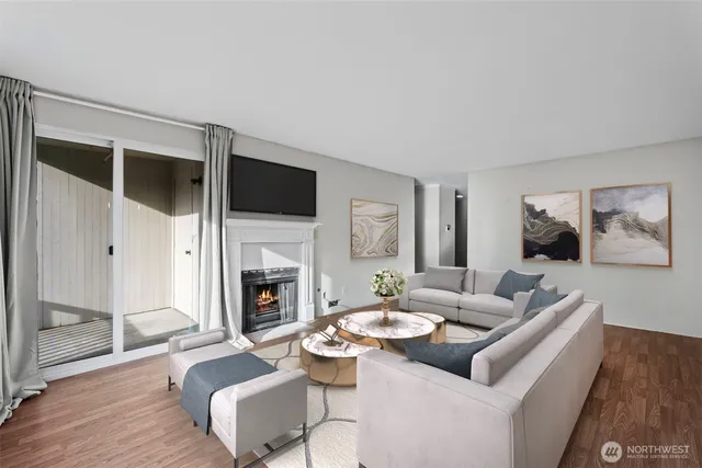 a living room with furniture fireplace and flat screen tv