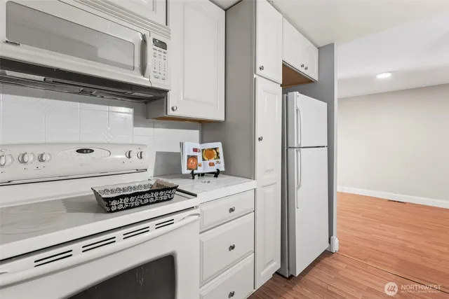 a kitchen with appliances and cabinets