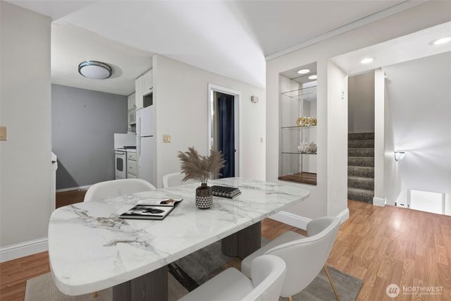 a dining room with furniture and wooden floor