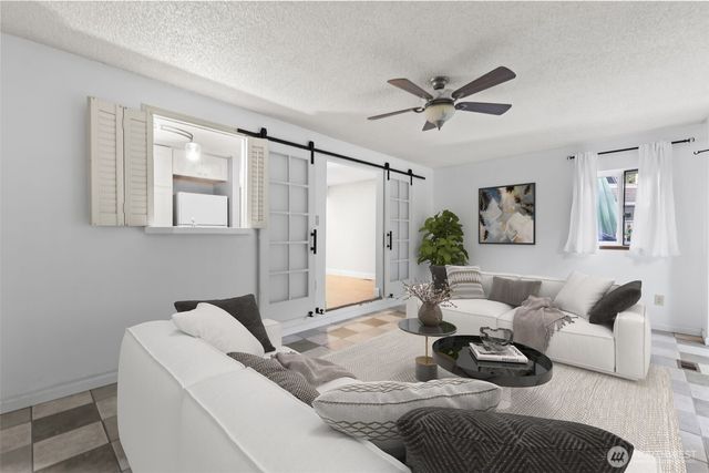 a living room with furniture and a large window