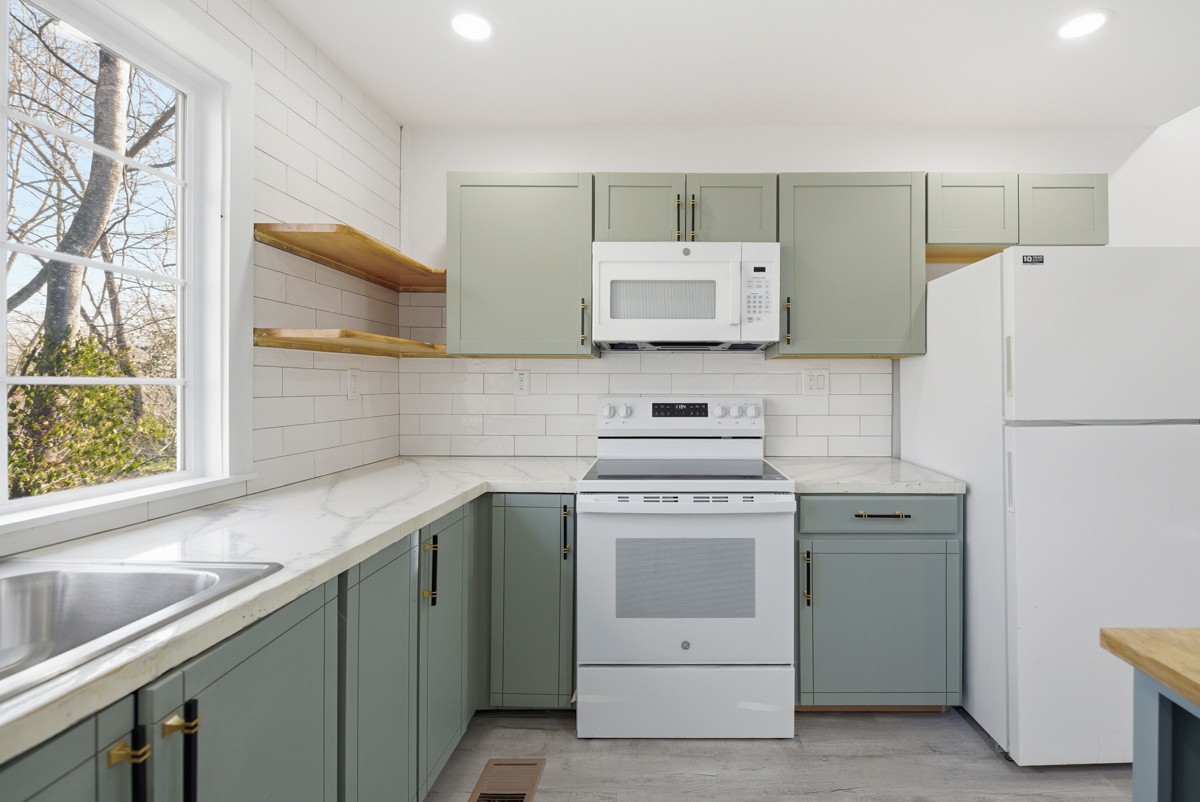 335 Columbia Avenue Centerville, TN 37033 - Photo 15 of 25 a kitchen with a stove sink and refrigerator