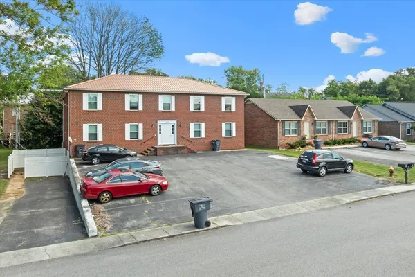 a view of a parked cars in front of a house