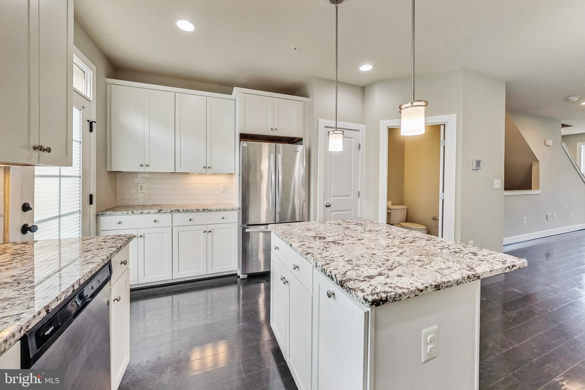 12609 Macaulay Street Silver Spring, MD 20906 - Photo 11 of 38 a kitchen with granite countertop a sink stove and refrigerator