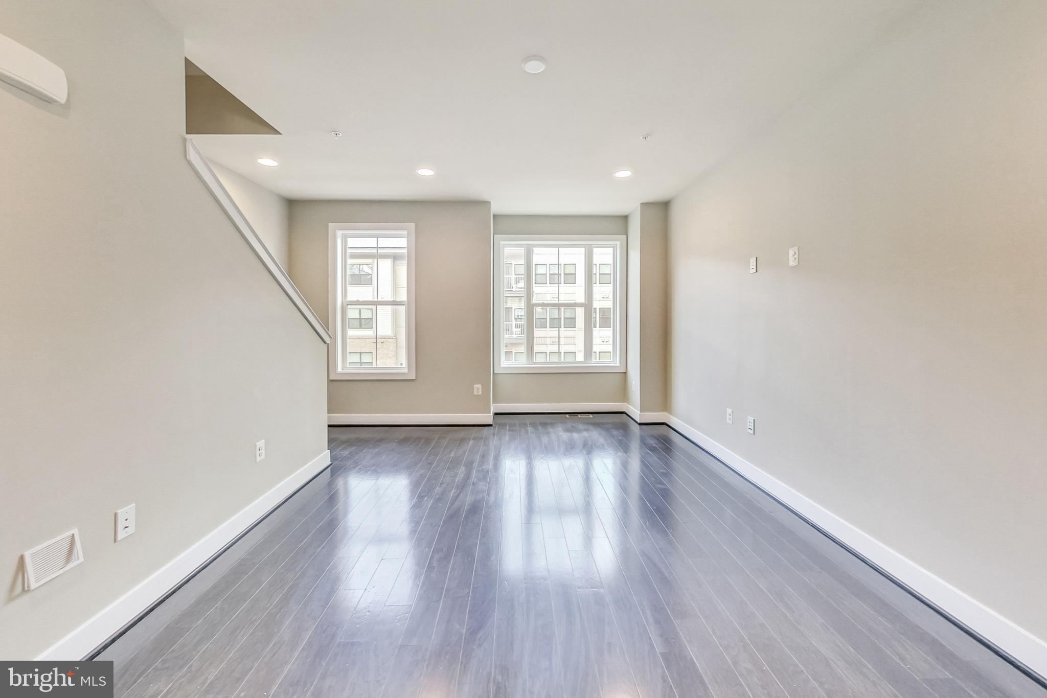 12609 Macaulay Street Silver Spring, MD 20906 - Photo 13 of 38 an empty room with wooden floor and windows