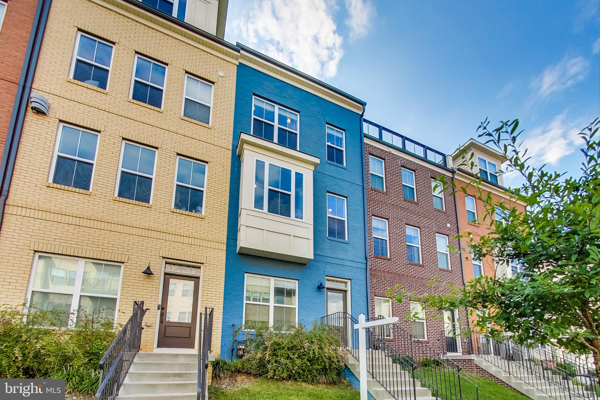 12609 Macaulay Street Silver Spring, MD 20906 - Photo 2 of 38 a front view of a building with a garden