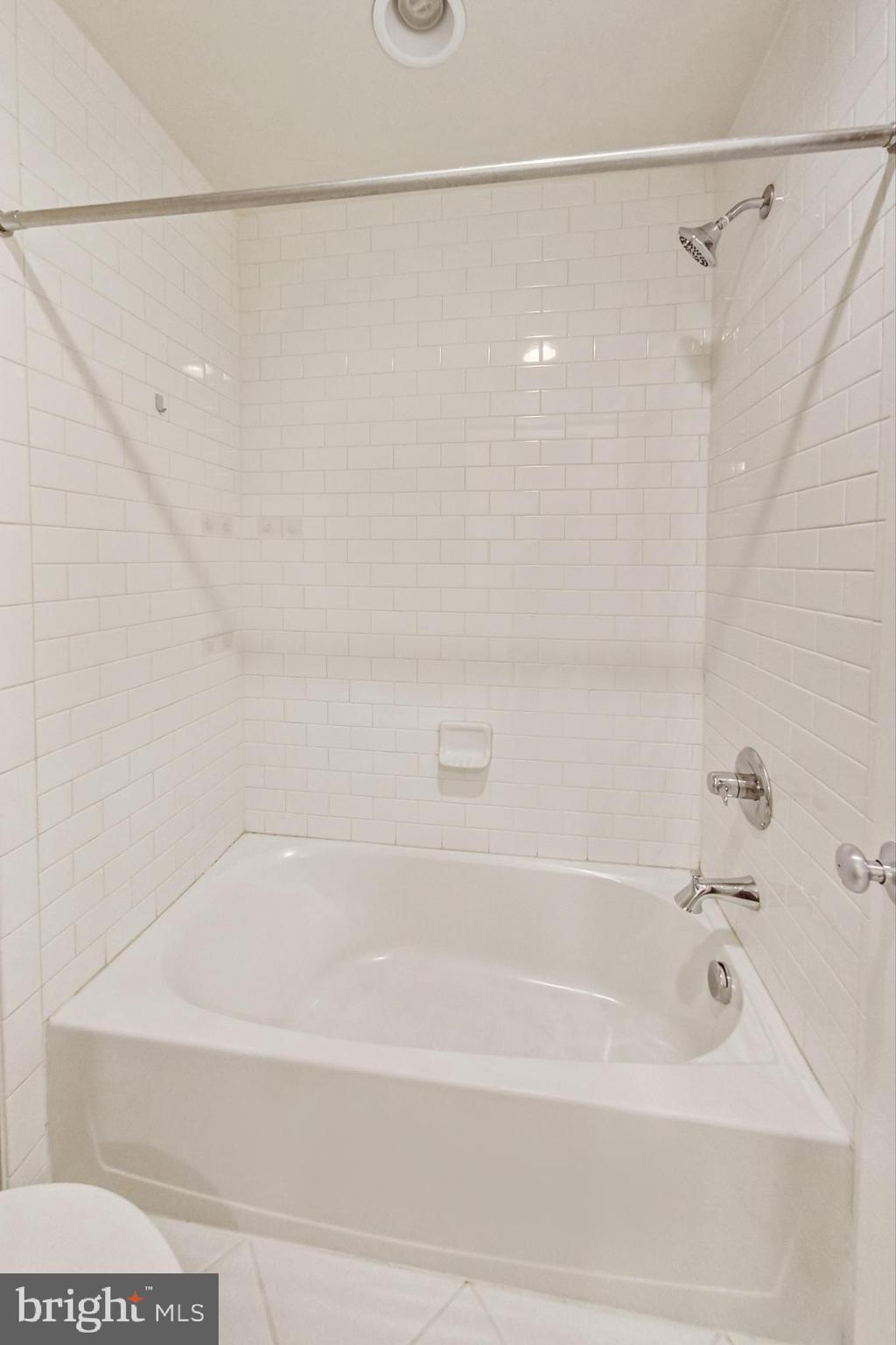 12609 Macaulay Street Silver Spring, MD 20906 - Photo 25 of 38 a bathroom with a shower and a bath tub