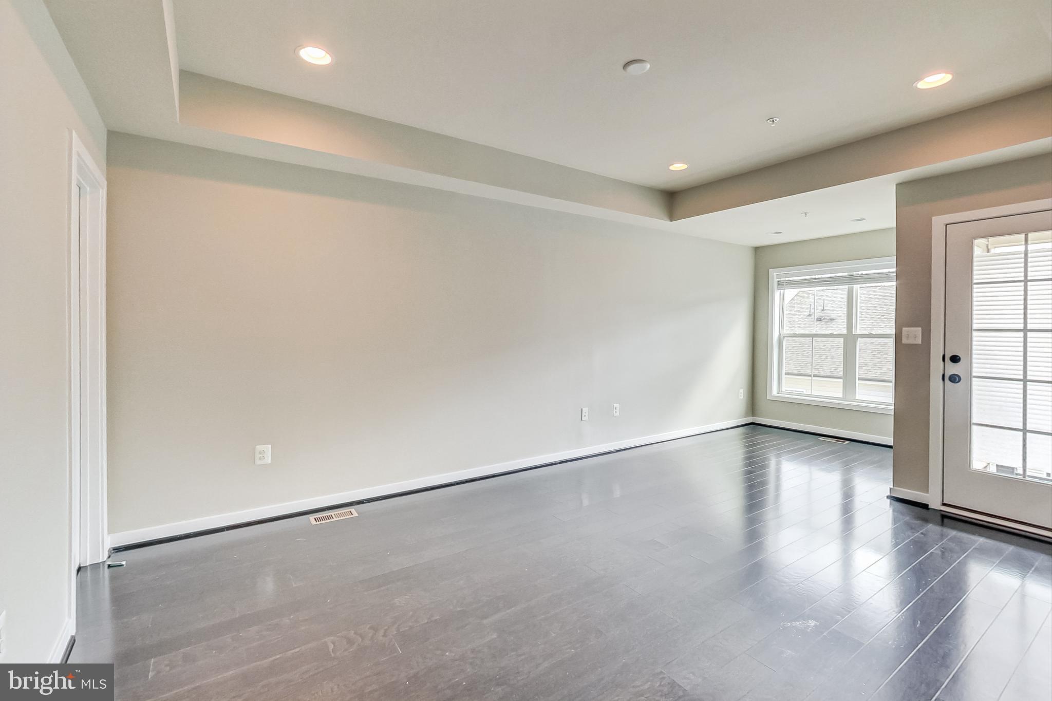 12609 Macaulay Street Silver Spring, MD 20906 - Photo 27 of 38 an empty room with wooden floor and windows
