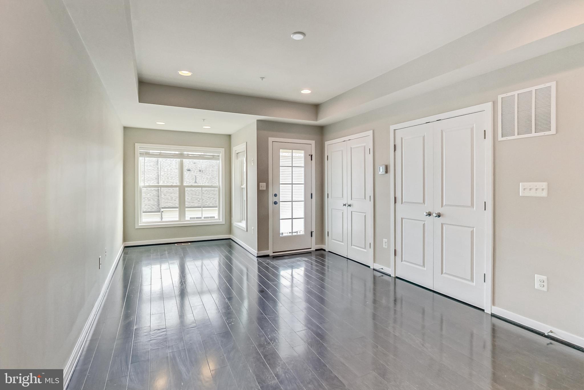 12609 Macaulay Street Silver Spring, MD 20906 - Photo 28 of 38 an empty room with wooden floor and windows