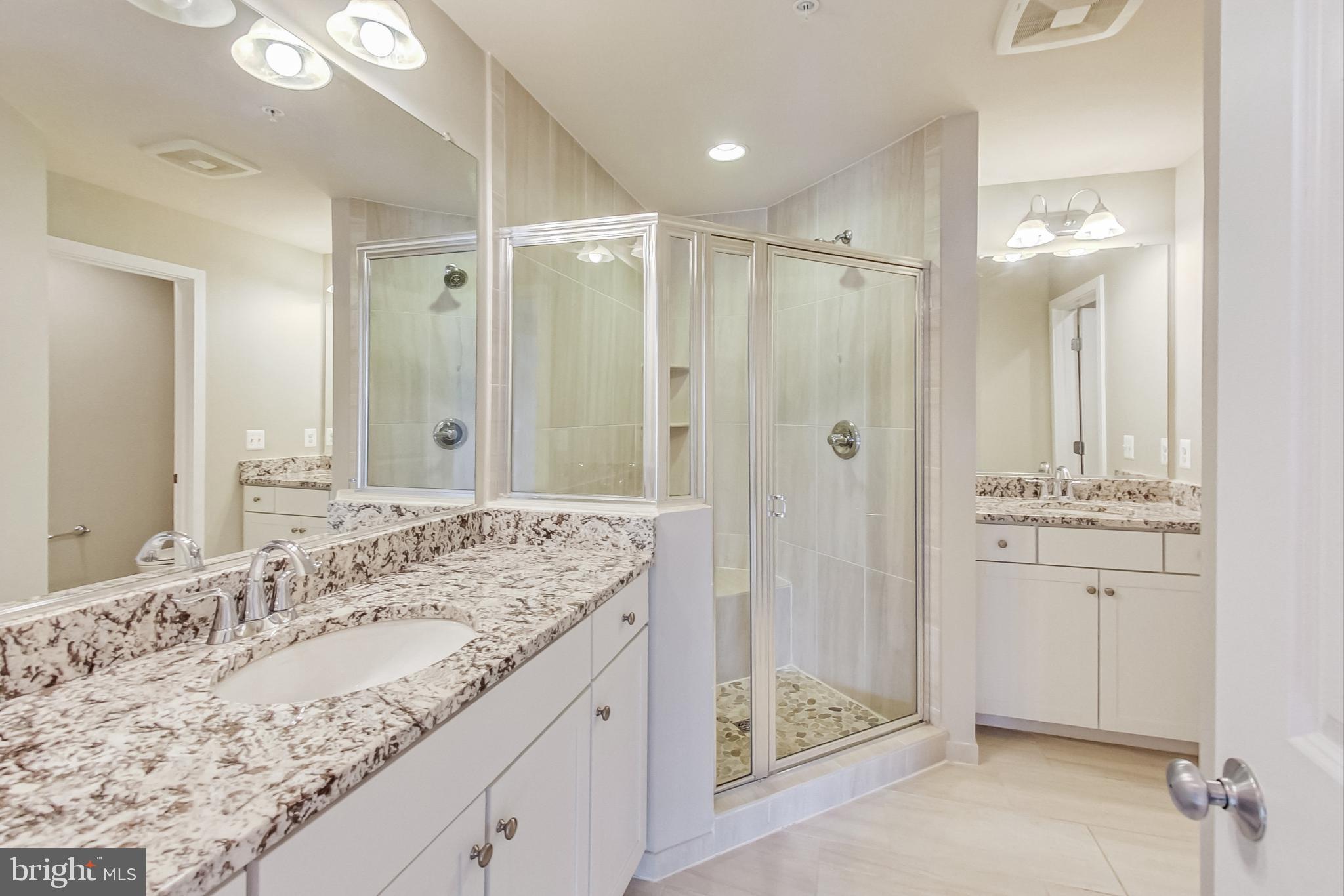 12609 Macaulay Street Silver Spring, MD 20906 - Photo 31 of 38 a bathroom with a shower sink and mirror