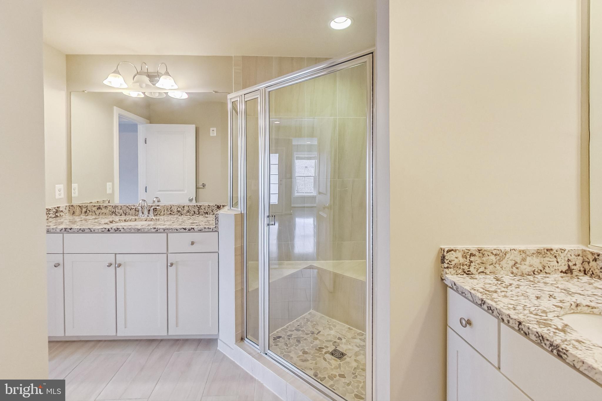 12609 Macaulay Street Silver Spring, MD 20906 - Photo 32 of 38 a bathroom with a granite countertop sink and a mirror