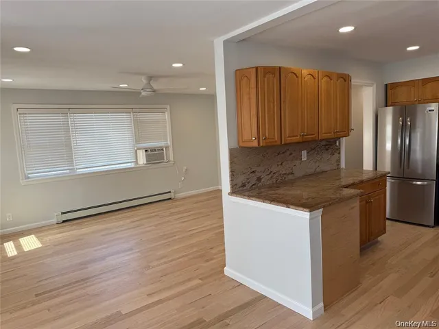 a kitchen with granite countertop wooden floors and stainless steel appliances