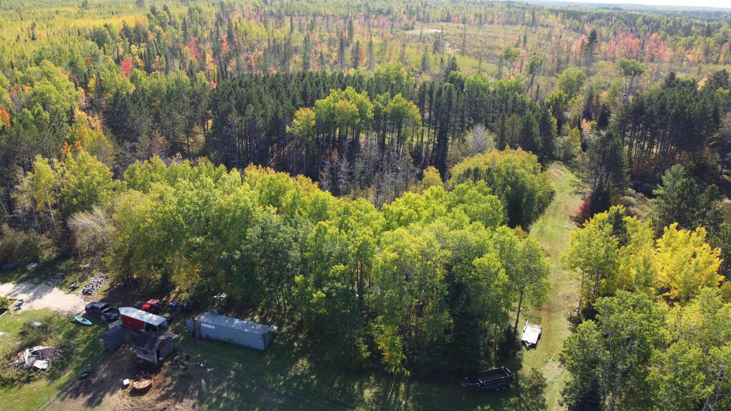 6821 Barrett Road Chisholm, MN 55719 - Photo 26 of 34 Aerial view of property and surrounding area with a heavily wooded area