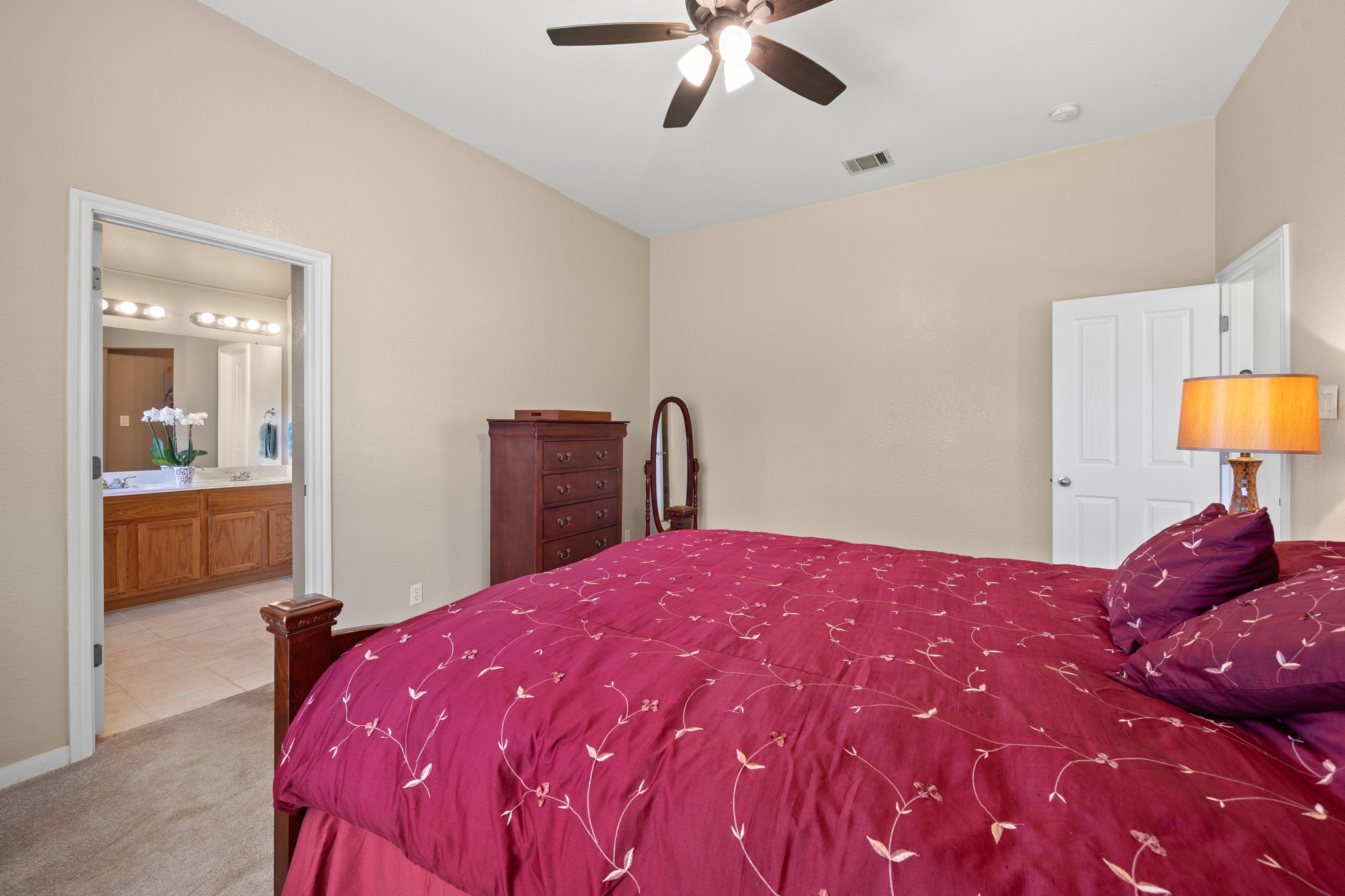 1108 Springbrook Road Pflugerville, TX 78660 - Photo 20 of 37 Relaxation awaits in this generous bedroom, offering a seamless connection to an ensuite bathroom.