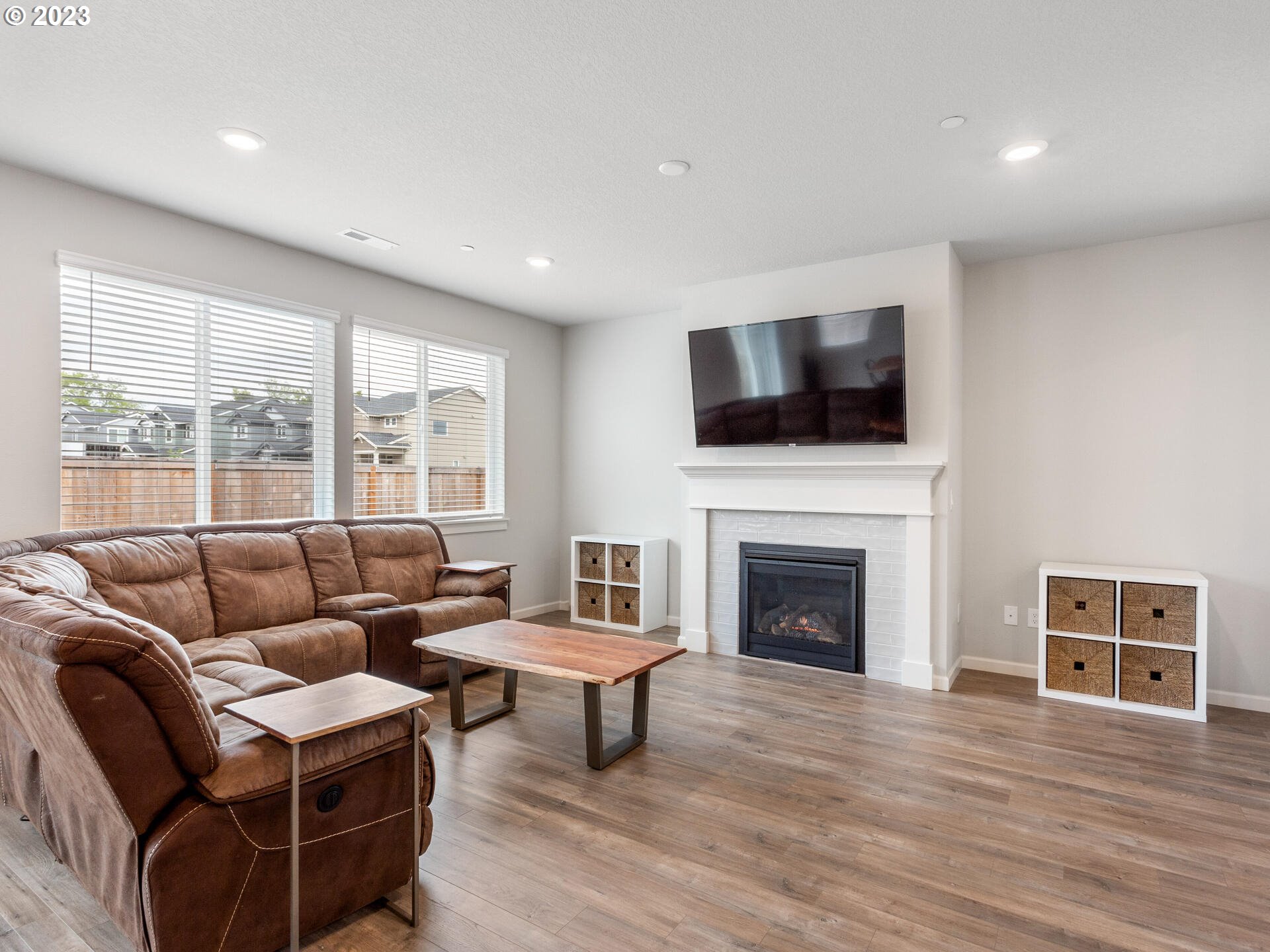 6852 North 89th Loop Camas, WA 98607 - Photo 13 of 38 a living room with furniture a fireplace and a flat screen tv