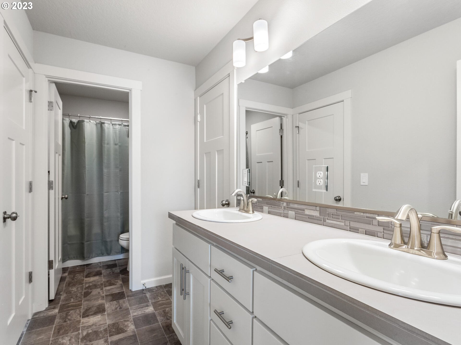 6852 North 89th Loop Camas, WA 98607 - Photo 24 of 38 a bathroom with a sink double vanity and a mirror