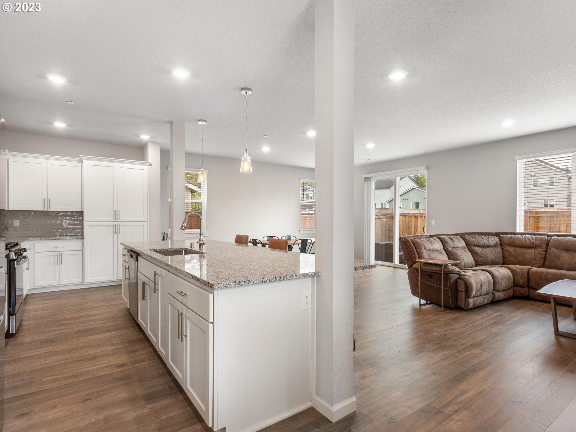 6852 North 89th Loop Camas, WA 98607 - Photo 5 of 38 a large kitchen with stainless steel appliances kitchen island granite countertop a large counter top and couches