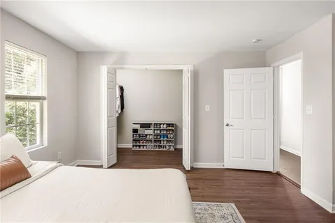 a view of walk in closet with clothes and shoes