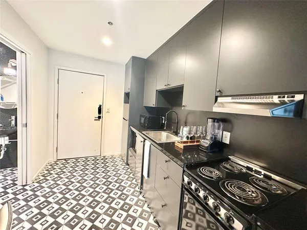 a kitchen with a sink cabinets and wooden floor