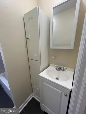a bathroom with a sink and mirror