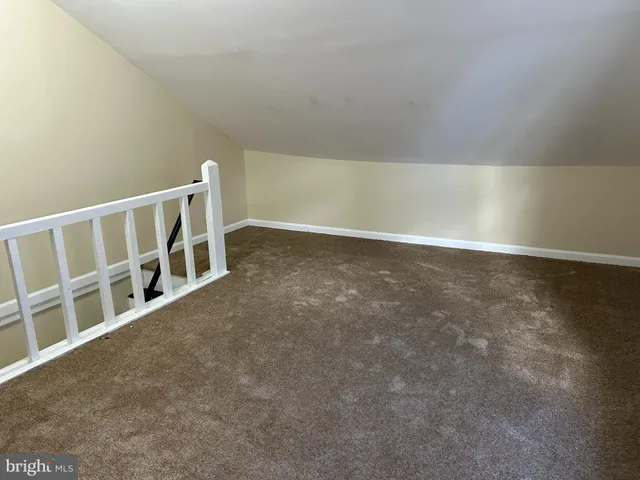 a view of an empty room with stairs