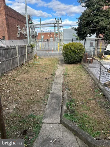 a view of a patio with table and chairs potted plants