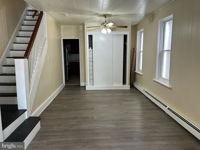 wooden floor in an empty room with a mirror