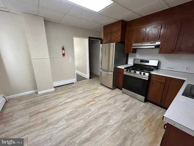 a kitchen with granite countertop cabinets and refrigerator