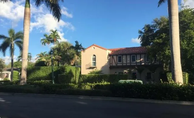 a view of a livingroom with furniture stairs and a black an umbrella