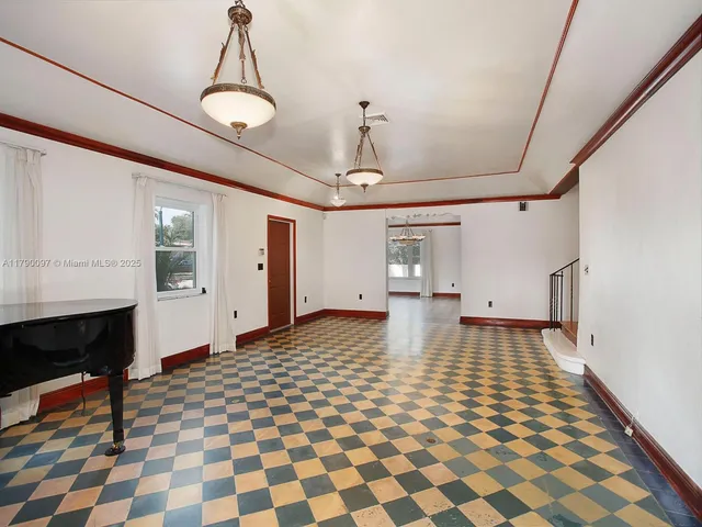 a view of a room with wooden floor and windows