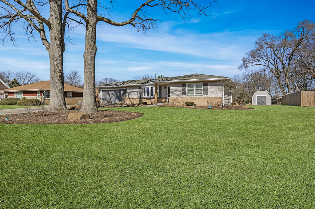 17528 Woodbrook Lane Lockport, IL 60441 - Photo 2 of 17 a view of a house with a big yard and large trees