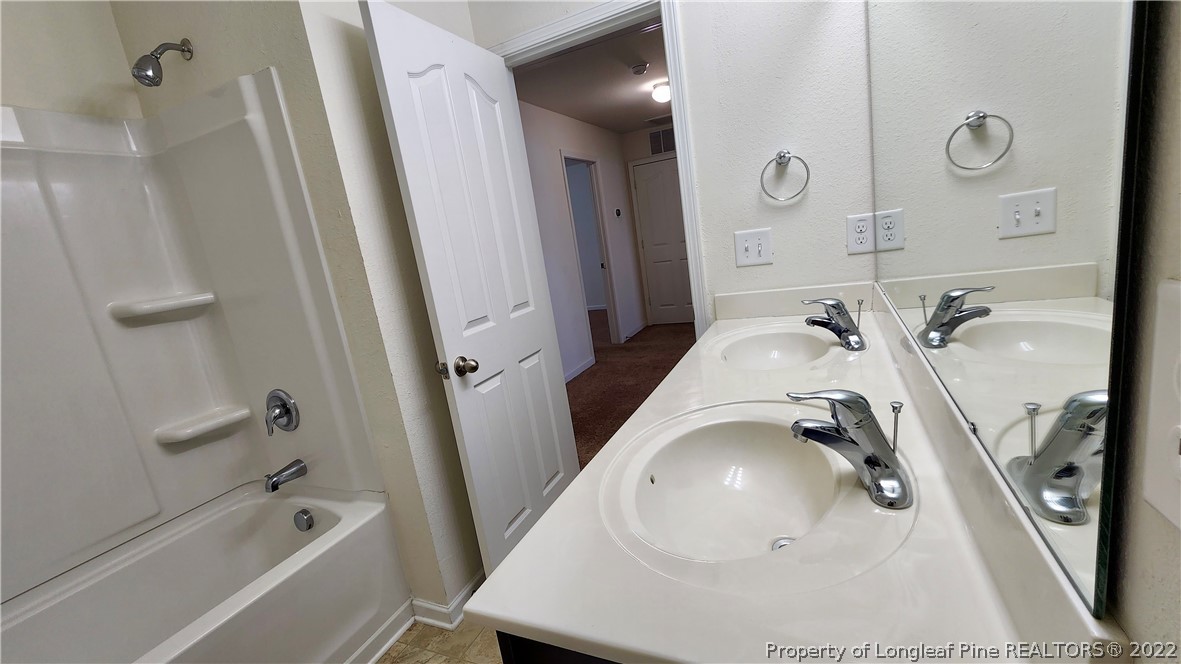 286 Botanical Court Bunnlevel, NC 28323 - Photo 14 of 39 a bathroom with a tub sink and mirror