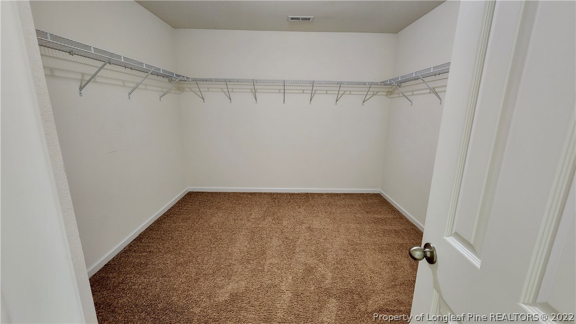 286 Botanical Court Bunnlevel, NC 28323 - Photo 21 of 39 a view of a room with racks on the wall