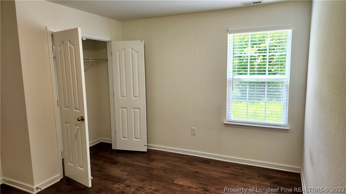286 Botanical Court Bunnlevel, NC 28323 - Photo 22 of 39 a view of an empty room with wooden floor and a window