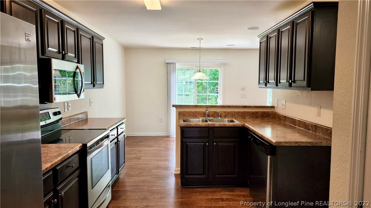 286 Botanical Court Bunnlevel, NC 28323 - Photo 23 of 39 a kitchen with stainless steel appliances granite countertop a sink stove and cabinets