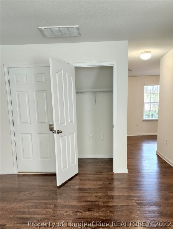 286 Botanical Court Bunnlevel, NC 28323 - Photo 27 of 39 a view of an empty room with wooden floor and a cabinet