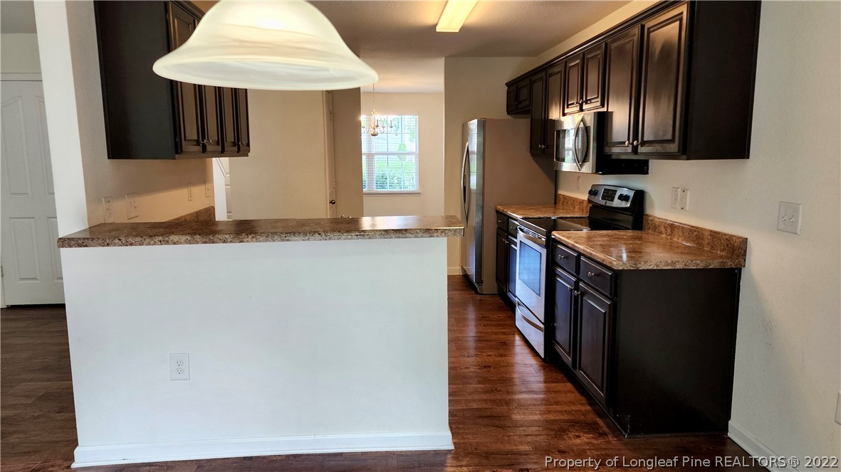 286 Botanical Court Bunnlevel, NC 28323 - Photo 28 of 39 a kitchen with stainless steel appliances granite countertop a sink stove and refrigerator