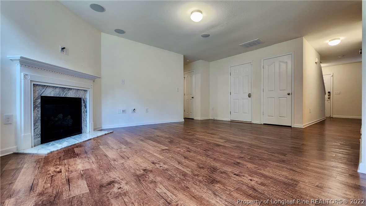 286 Botanical Court Bunnlevel, NC 28323 - Photo 30 of 39 a view of an empty room with wooden floor and a fireplace