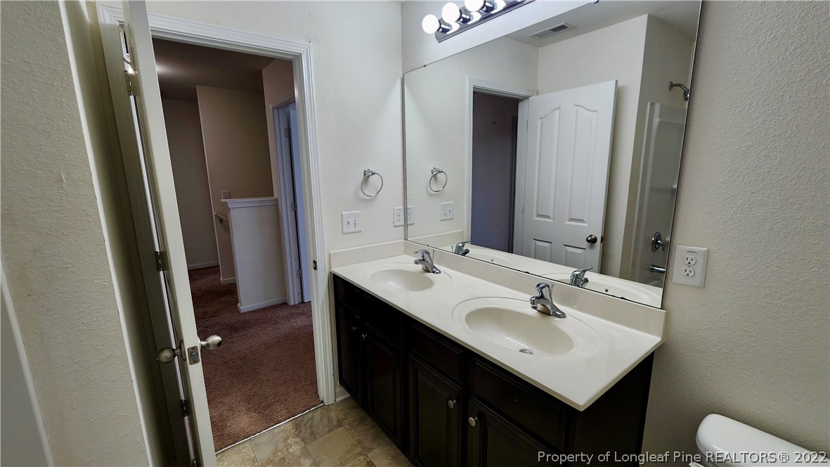 286 Botanical Court Bunnlevel, NC 28323 - Photo 33 of 39 a bathroom with a sink and a mirror