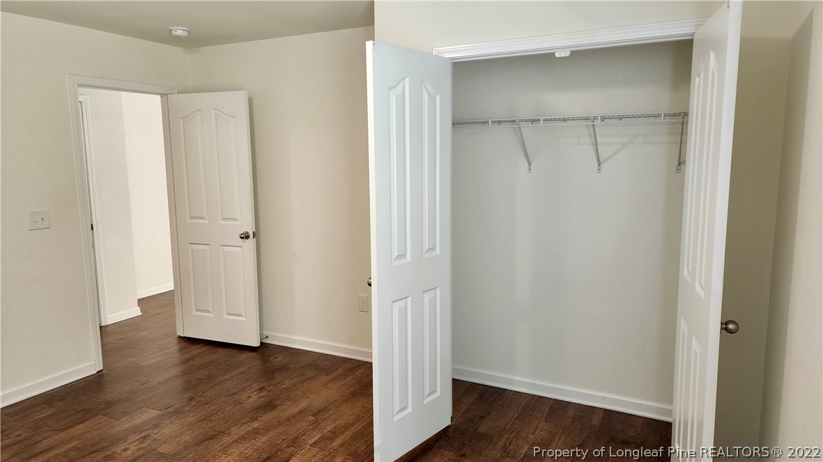 286 Botanical Court Bunnlevel, NC 28323 - Photo 4 of 39 a view of an empty room with wooden floor and closet