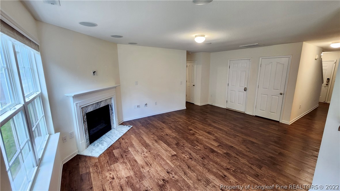 286 Botanical Court Bunnlevel, NC 28323 - Photo 5 of 39 a view of empty room with wooden floor and fireplace
