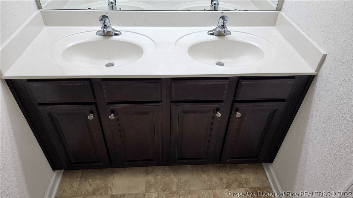 286 Botanical Court Bunnlevel, NC 28323 - Photo 7 of 39 a bathroom with a sink and a mirror