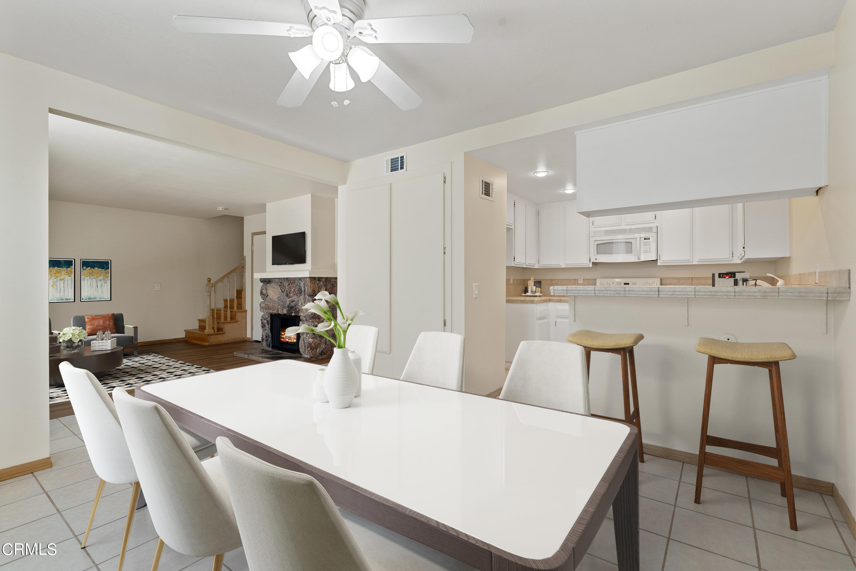 510 Spring Road, Unit 118 Moorpark, CA 93021 - Photo 5 of 24 a kitchen with a dining table chairs and white cabinets