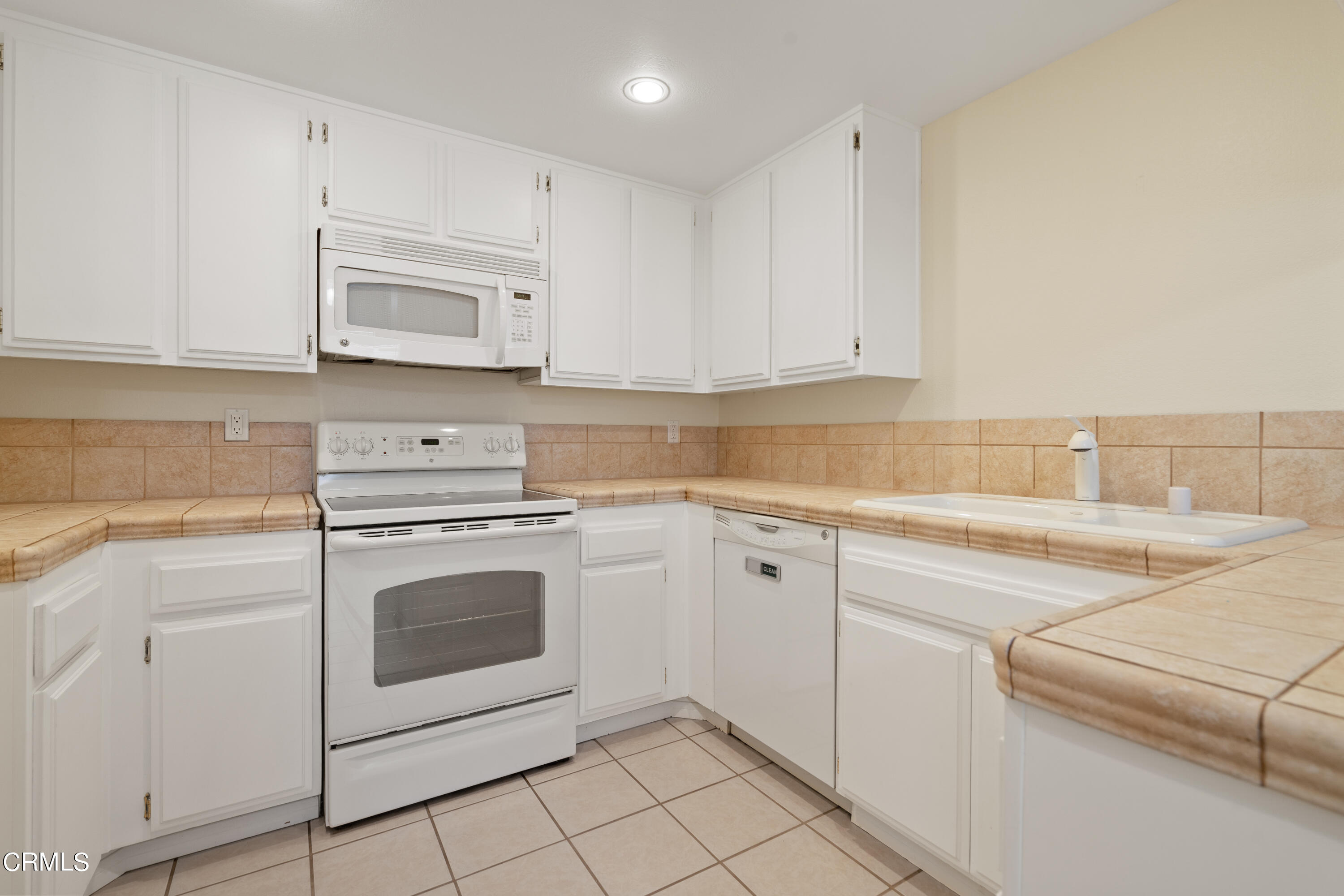 510 Spring Road, Unit 118 Moorpark, CA 93021 - Photo 6 of 24 a kitchen with cabinets stainless steel appliances and sink