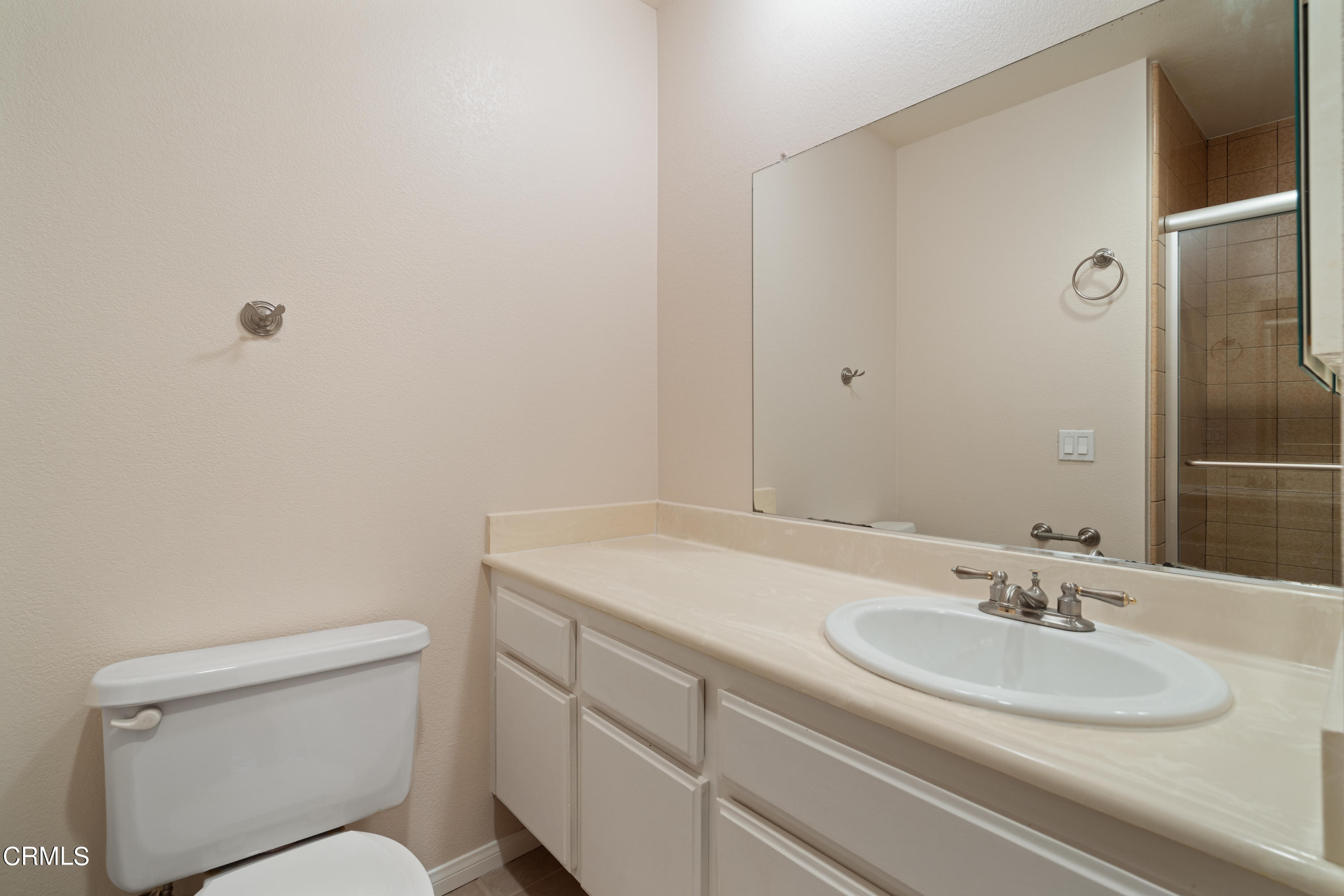 510 Spring Road, Unit 118 Moorpark, CA 93021 - Photo 10 of 24 a bathroom with a sink toilet and a mirror