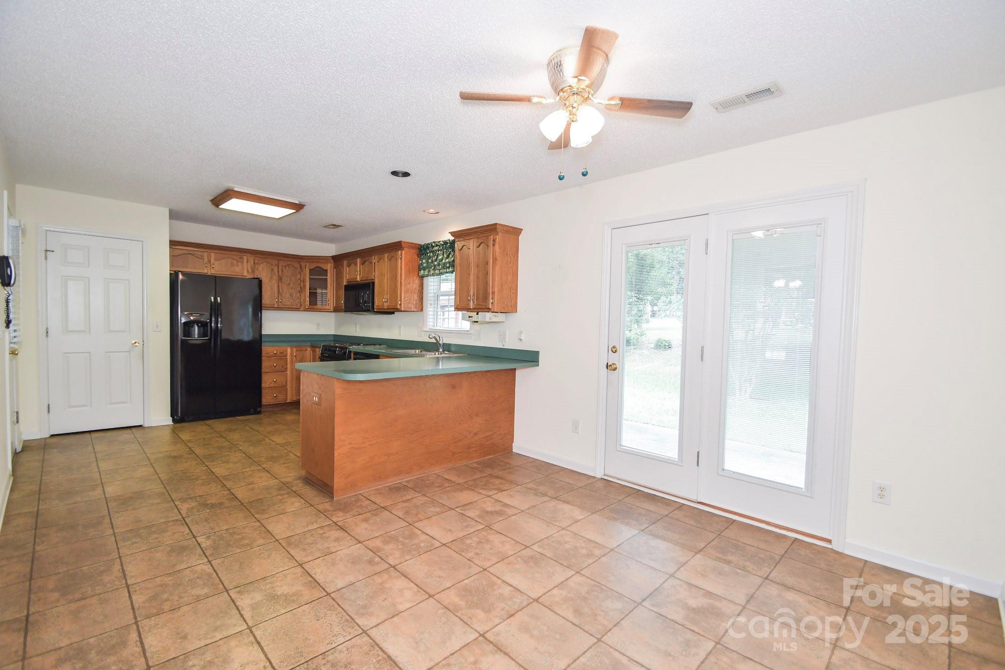 2718 Goldmine Road Monroe, NC 28110 - Photo 14 of 25 a large kitchen with stainless steel appliances granite countertop a refrigerator and a sink