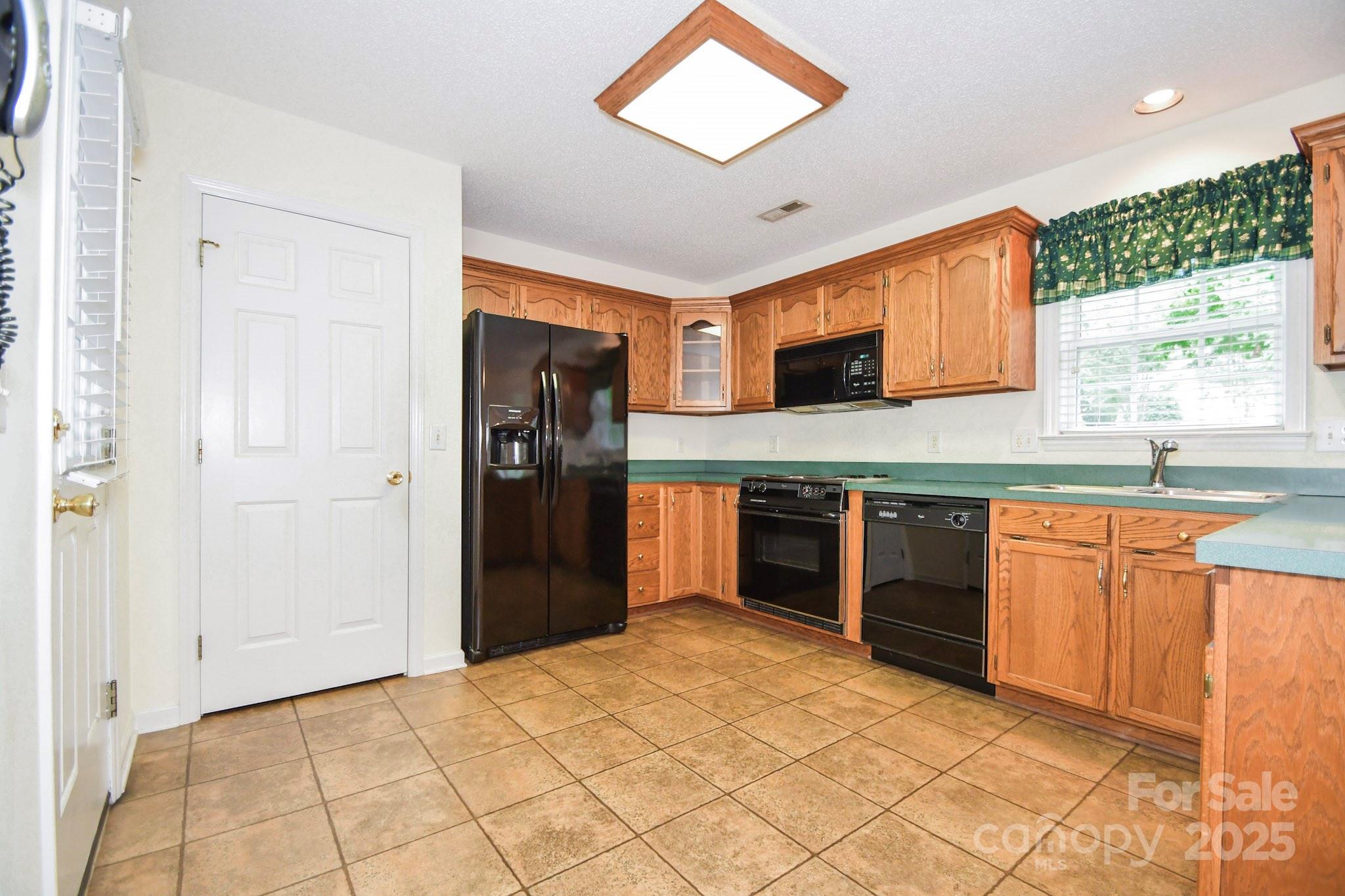 2718 Goldmine Road Monroe, NC 28110 - Photo 17 of 25 a kitchen with stainless steel appliances granite countertop a refrigerator and a sink