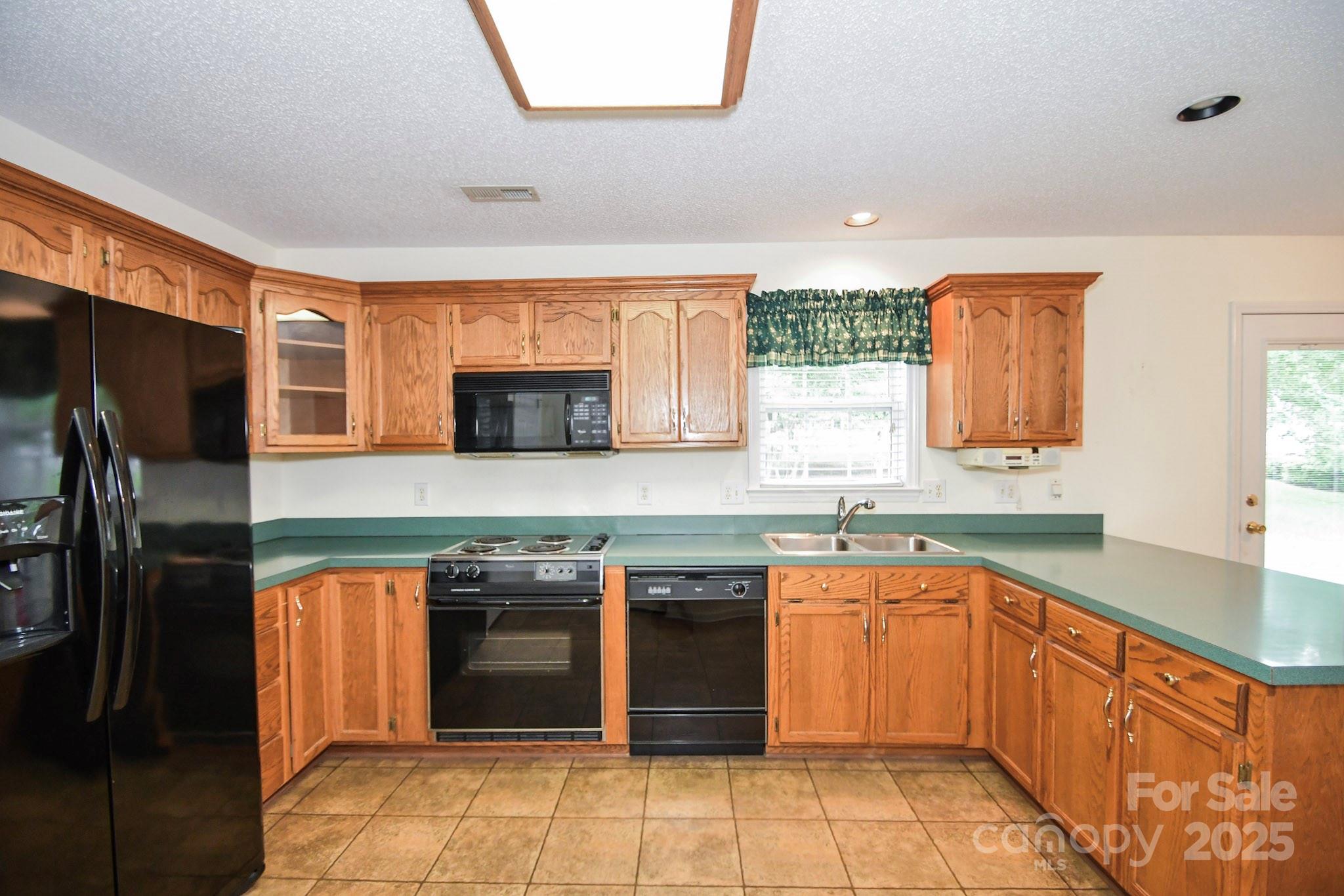 2718 Goldmine Road Monroe, NC 28110 - Photo 18 of 25 a kitchen with stainless steel appliances granite countertop a refrigerator and a sink